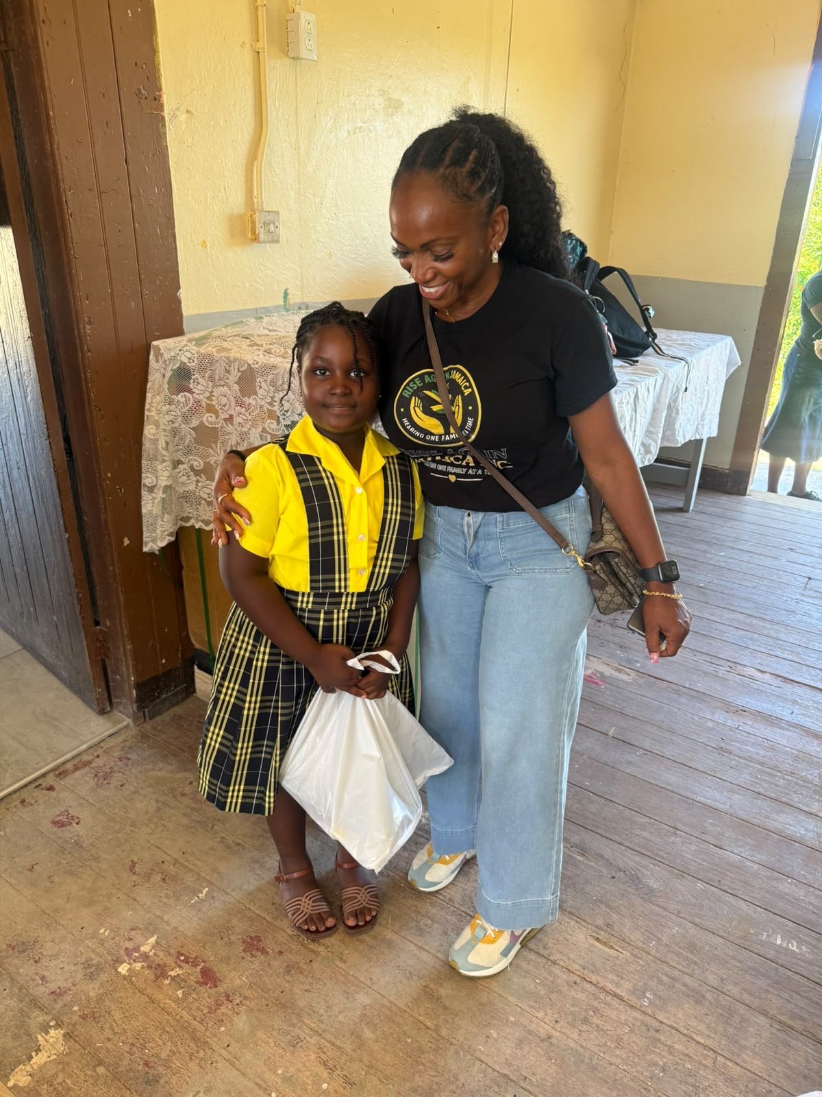 Michelle Ramundo with a student holding her new school supplies.