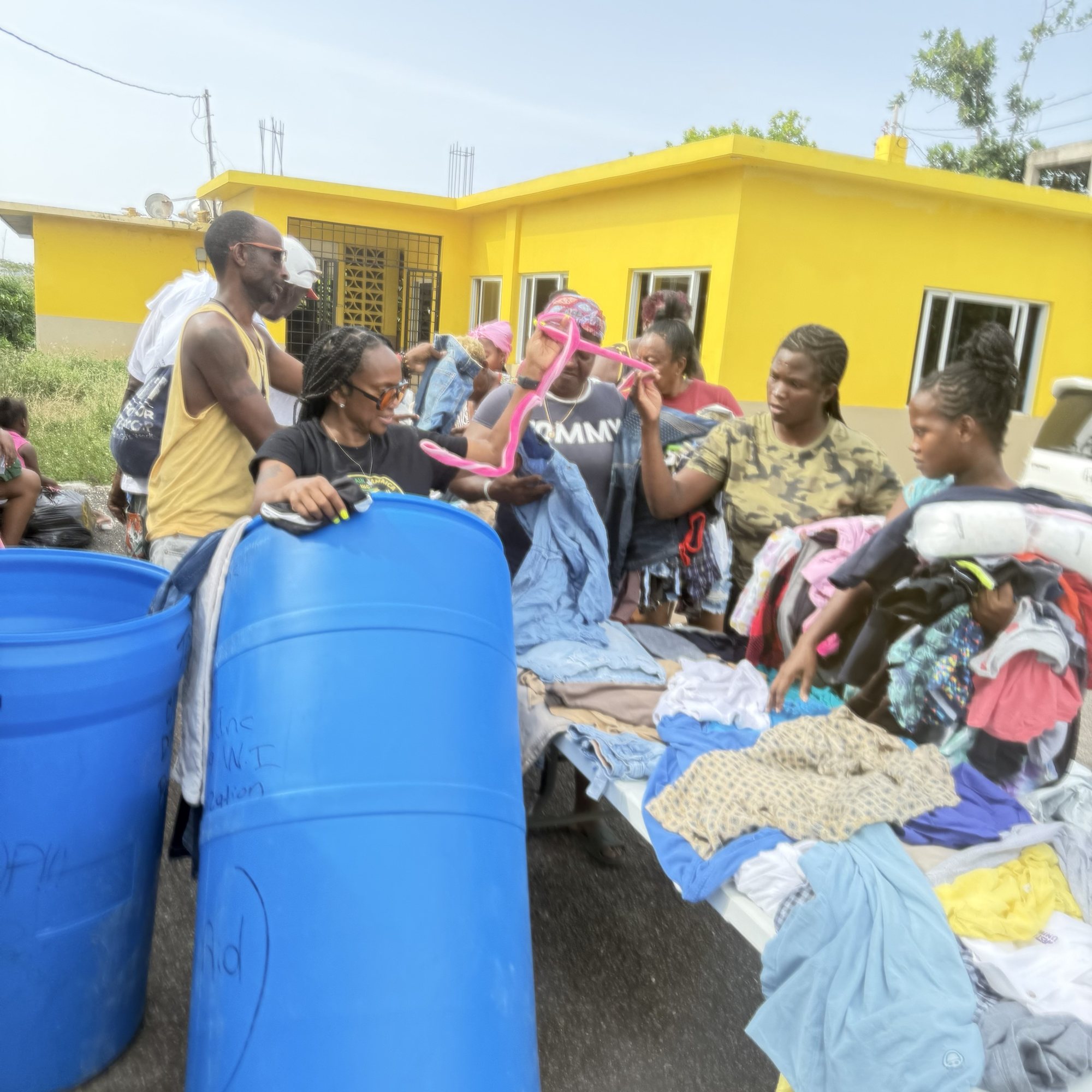 Tables of donated clothing set out for residents at a Rise Again Jamaica Incorporated distribution in Mount Salem.